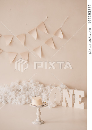 Small White Smash Cake on Vintage Stand with One Lettering and Bunting Flags in Neutral Beige Studio Small White Smash Cake on Vintage Stand with One Lettering and Bunting Flags in Neutral Beige Studio 142193885