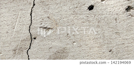 Cracked concrete wall with weathered surface detail Cracked concrete wall with weathered surface detail 142194069