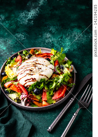 Salad with fresh burrata cheese, grilled peaches and blueberry Salad with fresh burrata cheese, grilled peaches and blueberry 142194285