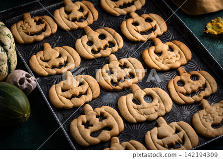 Halloween cookies in shape of jack-o-lantern Halloween cookies in shape of jack-o-lantern 142194309