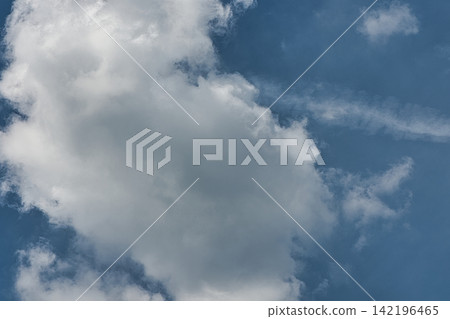 Large white clouds spread across the summer sky. Large white clouds spread across the summer sky. 142196465