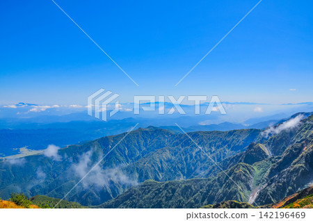 On a clear autumn morning, the Yatsugatake mountain range, Mount Fuji, and the Southern Alps can be seen in the distance from the hiking trail of Mt. Karamatsu. On a clear autumn morning, the Yatsugatake mountain range, Mount Fuji, and the Southern Alps can be seen in the distance from the hiking trail of Mt. Karamatsu. 142196469