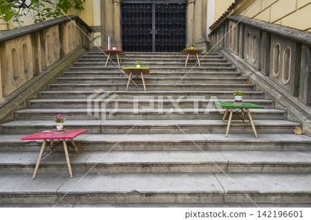 Colorful small tables with potted plants are placed on a wide stone staircase  in Brno, Czech Republic 142196601