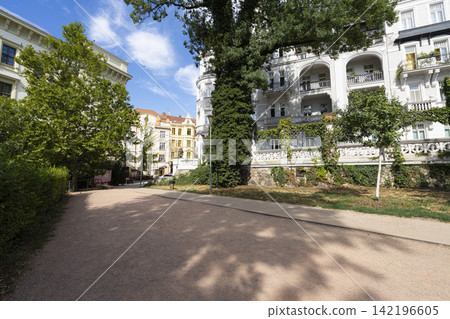 wide gravel path curves past lush green trees in Brno, Czech Republic wide gravel path curves past lush green trees in Brno, Czech Republic 142196605