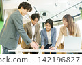 Four young Japanese men and women having a meeting in the office. Four young Japanese men and women having a meeting in the office. 142196827