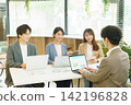 Four young Japanese men and women having a meeting in the office. Four young Japanese men and women having a meeting in the office. 142196828