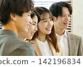 The faces of a young Japanese man and woman standing side by side in an office The faces of a young Japanese man and woman standing side by side in an office 142196834