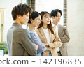 Close-ups of the faces of a young Japanese man and woman standing side by side in an office. Close-ups of the faces of a young Japanese man and woman standing side by side in an office. 142196835