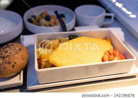 A delicious cheese omelet for breakfast in business class on an international flight of a European airline. A delicious cheese omelet for breakfast in business class on an international flight of a European airline. 142196876