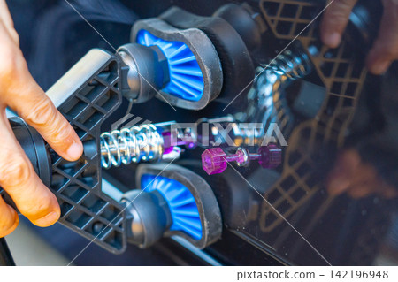 Removing dents on the car. PDR technology. Car body repair without painting. Removing dents on the car. PDR technology. Car body repair without painting. 142196948