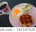 Homemade breakfast plate with waffles and fried eggs 142197226