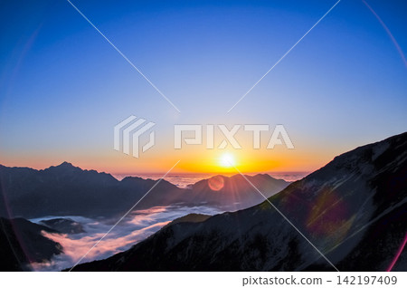 Autumn twilight: A beautiful view from Mt. Karamatsu of the gradient-colored evening sky and the sun setting behind Mt. Nekomata. Autumn twilight: A beautiful view from Mt. Karamatsu of the gradient-colored evening sky and the sun setting behind Mt. Nekomata. 142197409