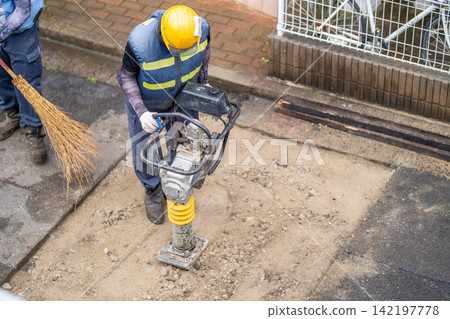 瀝青鋪路前的路基準備:夯實機、碎石、整平、鋪面、壓實、竹掃帚。 瀝青鋪路前的路基準備:夯實機、碎石、整平、鋪面、壓實、竹掃帚。 142197778