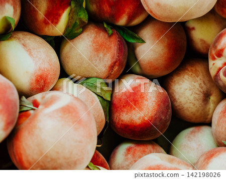 Fresh Ripe Peaches with Green Leaves Fresh Ripe Peaches with Green Leaves 142198026