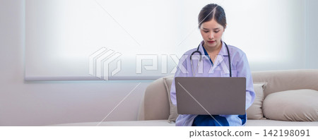 Asian doctor wearing white medical uniform sit at desk using modern laptop Asian doctor wearing white medical uniform sit at desk using modern laptop 142198091