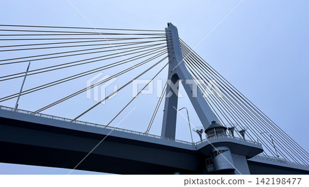 Low-angle view of Aomori Bay Bridge pylon and radiating cables Low-angle view of Aomori Bay Bridge pylon and radiating cables 142198477