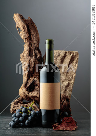 Red wine with stone, dried snags, and blue grapes. 142198993