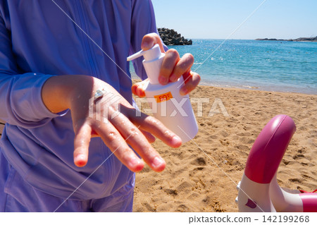 SPF, hands and girl on beach, sand and skincare for summer holiday in Korea SPF, hands and girl on beach, sand and skincare for summer holiday in Korea 142199268