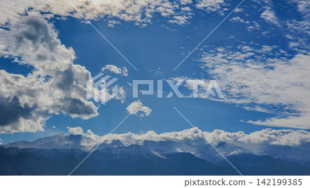 Snow capped White Mountains Lefka Ori range under bright blue sky with cumulus clouds in Crete island Greece winter landscape stock photo Snow capped White Mountains Lefka Ori range under bright blue sky with cumulus clouds in Crete island Greece winter landscape stock photo 142199385