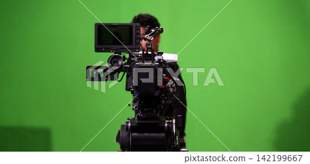 Behind the scenes. BTS of TV commercial movie film or video shooting production which pro camera crew setting up on green screen for chroma key technique in studio. Greenscreen background shooting set Behind the scenes. BTS of TV commercial movie film or video shooting production which pro camera crew setting up on green screen for chroma key technique in studio. Greenscreen background shooting set 142199667