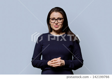 Portrait of smiling mature 40s woman in glasses looking at camera Portrait of smiling mature 40s woman in glasses looking at camera 142199766