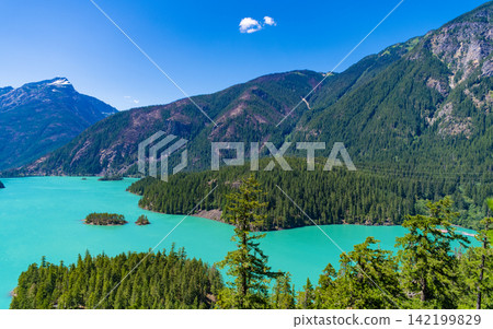 Landscape of mountain peak and Diablo lake. Nature landscape. Diablo Lake in North Cascades National Park. Scenic nature view over lake. Diablo lake with mountain landscape. Diablo wilderness Landscape of mountain peak and Diablo lake. Nature landscape. Diablo Lake in North Cascades National Park. Scenic nature view over lake. Diablo lake with mountain landscape. Diablo wilderness 142199829