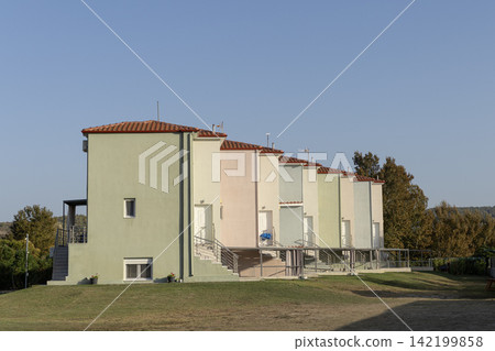 Row of modern pastel colored villas and vacation houses 142199858