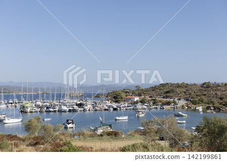 Marina with sailboats and yachts in a Mediterranean bay Marina with sailboats and yachts in a Mediterranean bay 142199861