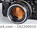 Black retro analog camera lens front view isolated on white background 142200010
