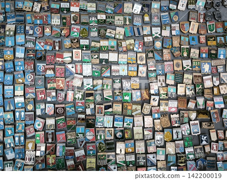 Dense arrangement of city coat-of-arms icons against the background Dense arrangement of city coat-of-arms icons against the background 142200019