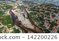 Aerial view of the Grande River and sandbars surrounding the red-tiled village of Santo Amaro. 142200226
