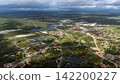 Aerial view of a village on the outskirts of Santo Amaro, shrouded in rain clouds and covered in puddles. 142200227