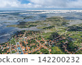 Aerial view of the houses of Santo Amaro, stretching from wetlands to white sand dunes. 142200232