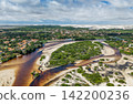 Aerial view of the Grande River winding around a green sandbar with white sand dunes in the background, Santo Amaro 142200236