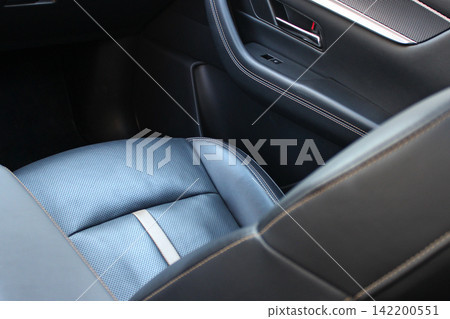 Stitching and decoration of different types of leather trim for seats in car interiors. Car seats inside premium car. Vehicle interior upholstery Stitching and decoration of different types of leather trim for seats in car interiors. Car seats inside premium car. Vehicle interior upholstery 142200551