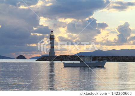 Seascape at sunshine. Lighthouse and sailings on the coast. Seaside town of Turgutreis and spectacular sunshine Seascape at sunshine. Lighthouse and sailings on the coast. Seaside town of Turgutreis and spectacular sunshine 142200603
