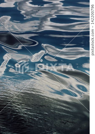 magic reflections on water surface, sailing regatta in the Gulf of Finland at sunny day, Yachtsmen are sitting amicably on board of the sailing boat, teamwork magic reflections on water surface, sailing regatta in the Gulf of Finland at sunny day, Yachtsmen are sitting amicably on board of the sailing boat, teamwork 142200796