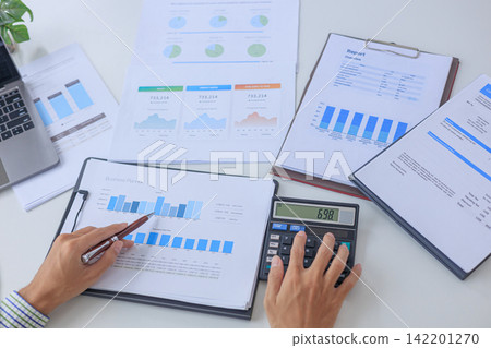 Top View of Corporate Auditor Conducting Financial Performance Review and Budget Variance Analysis at Modern Office Desk. Top View of Corporate Auditor Conducting Financial Performance Review and Budget Variance Analysis at Modern Office Desk. 142201270