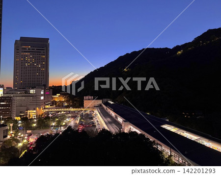 Shin-Kobe Station and Mount Rokko just after sunset, with the sky painted in shades of blue, purple, and orange. Shin-Kobe Station and Mount Rokko just after sunset, with the sky painted in shades of blue, purple, and orange. 142201293