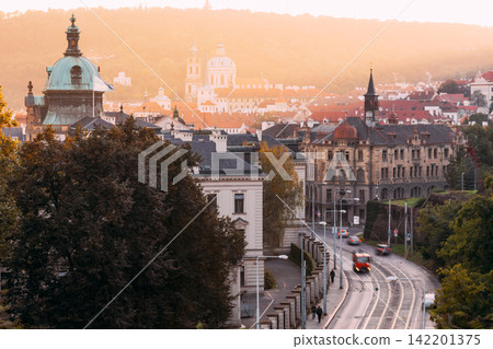 City street leading to St. Nicholas Church in Prague at sunset City street leading to St. Nicholas Church in Prague at sunset 142201375