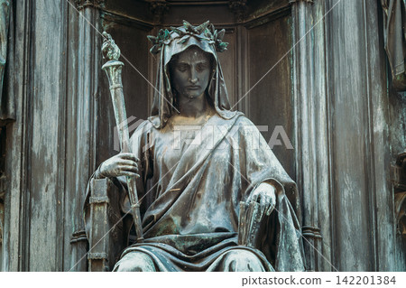 Seated bronze figure on Historic Krizovnicke Square and Charles IV statue 142201384