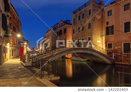 Venetian Canal with Bridges and Reflections Before Sunrise in Venice, Italy Venetian Canal with Bridges and Reflections Before Sunrise in Venice, Italy 142201403