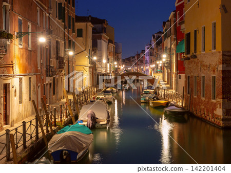 Venetian Canal with Bridges and Reflections Before Sunrise in Venice, Italy Venetian Canal with Bridges and Reflections Before Sunrise in Venice, Italy 142201404