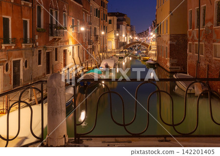Venetian Canal with Bridges and Reflections Before Sunrise in Venice, Italy 142201405