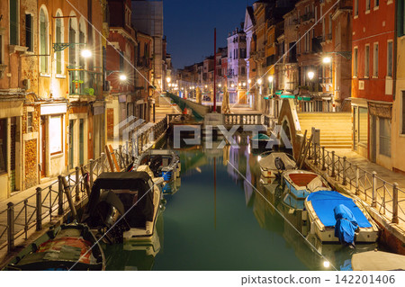 Venetian Canal with Bridges and Reflections Before Sunrise in Venice, Italy Venetian Canal with Bridges and Reflections Before Sunrise in Venice, Italy 142201406