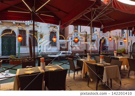 Canal Side Restaurant Terrace with Traditional Architecture in Venice, Italy Canal Side Restaurant Terrace with Traditional Architecture in Venice, Italy 142201410