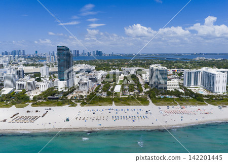 Miami beach with turquoise waters. Aerial view of sandy coastline and waves. Tropical Miami Beach scene with sandy beach. Oceanfront of South Miami. 142201445