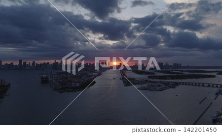 Miami skyscrapers above the coastline at sunset. Miamis coastal landscape from above. Top view of Miami shoreline. Aerial view of Miami beach and ocean. Miami coastline on night. Miami skyscrapers above the coastline at sunset. Miamis coastal landscape from above. Top view of Miami shoreline. Aerial view of Miami beach and ocean. Miami coastline on night. 142201450