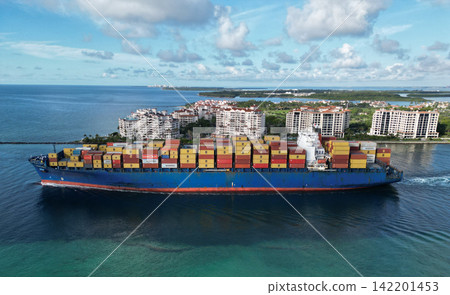 Miami, Florida, USA - June 07, 2024: Freight container loaded on cargo vessel in Miami. Aerial view cargo ship leaving port of Miami. Container ship. Cargo ship with container in Miami, aerial view Miami, Florida, USA - June 07, 2024: Freight container loaded on cargo vessel in Miami. Aerial view cargo ship leaving port of Miami. Container ship. Cargo ship with container in Miami, aerial view 142201453
