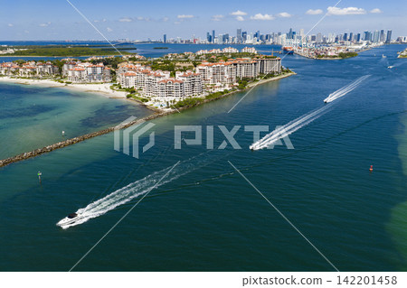 Aerial view of boats on turquoise waters in Miami. Yacht retreat in Miami. Cityscape with sailing vessels in Miami. 142201458